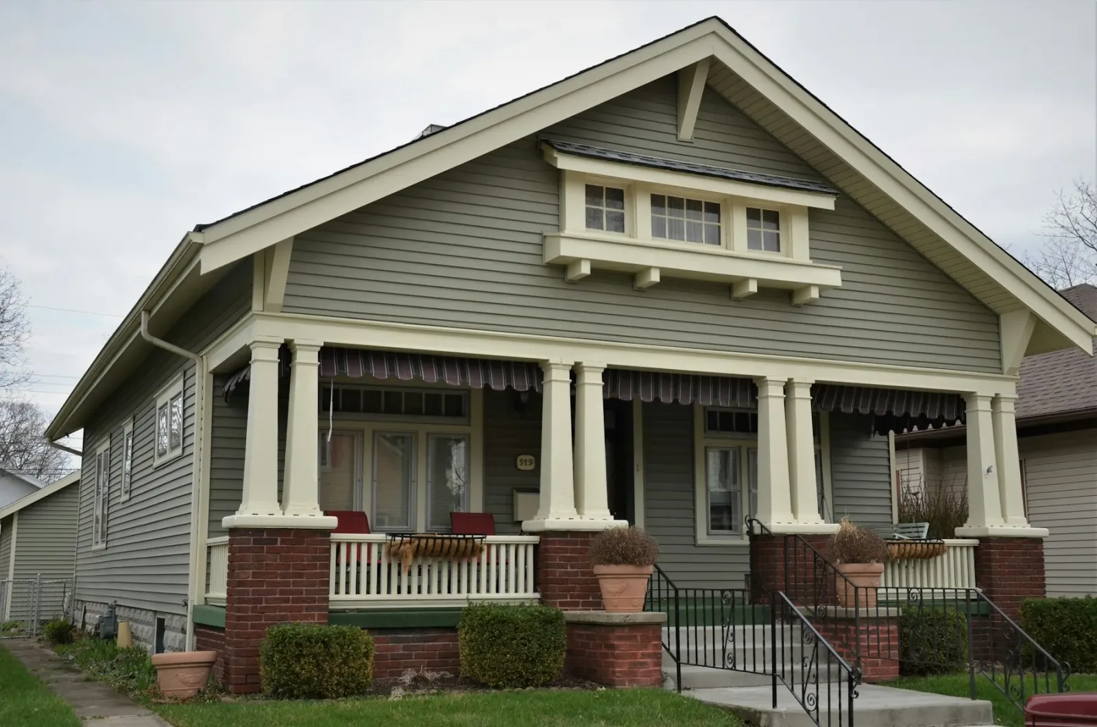 Craftsman home with clean windows and a tidy roofline under a grey Pacific Northwest sky